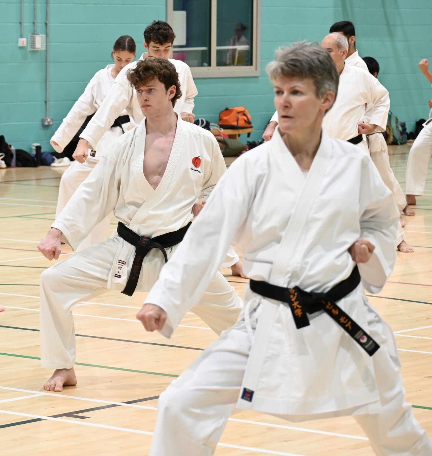 people in white suits, practising Karate
