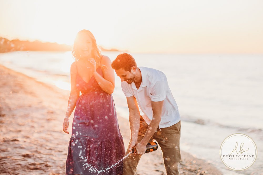 best engagement proposal photographer near rochester ny irondequoit beach sunset golden hour champag