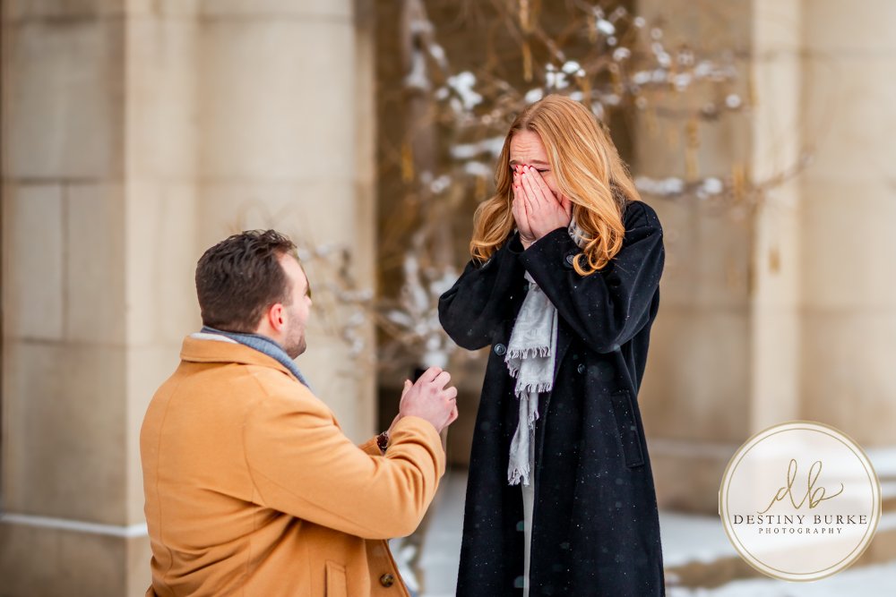 best surprise proposal and engagement portraits luxery winter snow george eastman museum